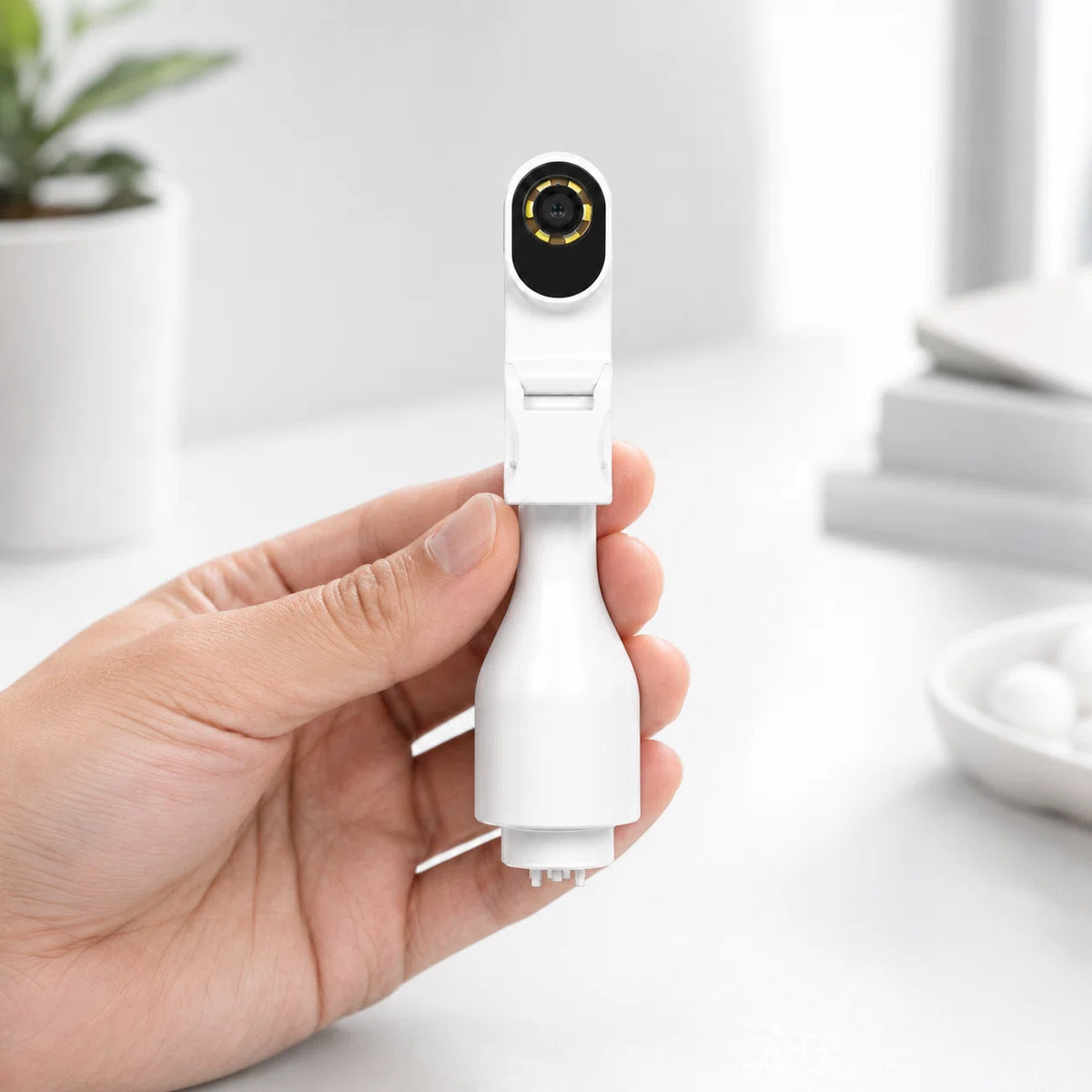 Hand holding Sofbunny A03 oral camera attachment with LED lights
